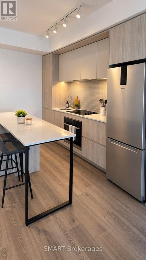 A modern kitchen with a table and chairs.