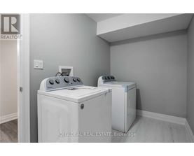 A white washer and dryer in a laundry room.