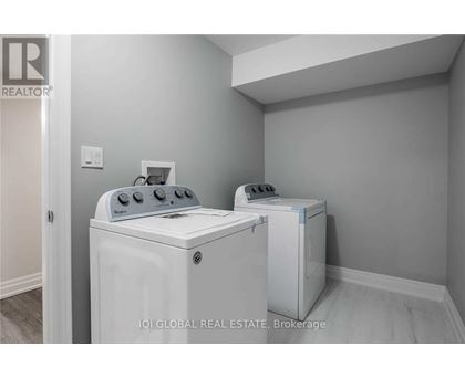 A white washer and dryer in a laundry room.