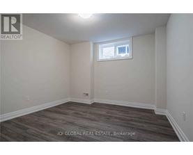A room with a window and wooden flooring.