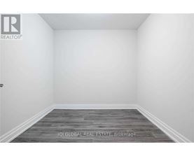 A room with a wooden floor and white walls.
