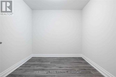 A room with a wooden floor and white walls.