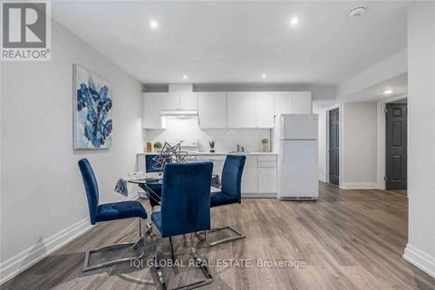 A modern kitchen with a dining table set up with blue chairs.
