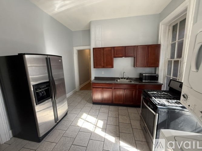 A kitchen with a stainless steel refrigerator and oven.