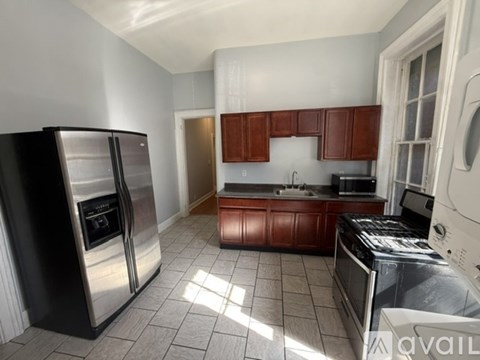 A kitchen with a stainless steel refrigerator and oven.