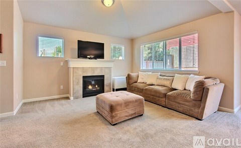 A living room with a fireplace and a couch.