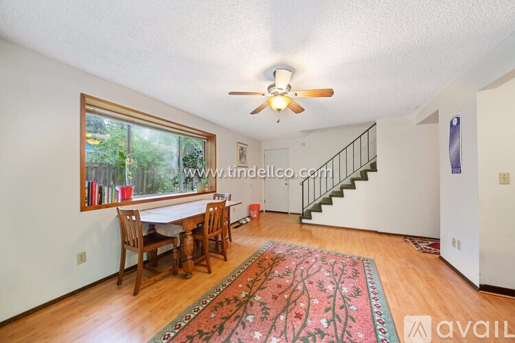 A dining room with a table and chairs.