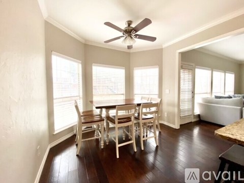 A dining room with a table set for six.