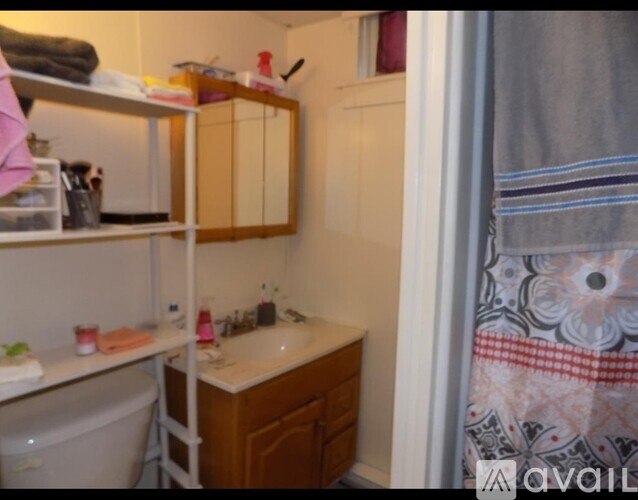 A bathroom with a sink, mirror, and towel rack.
