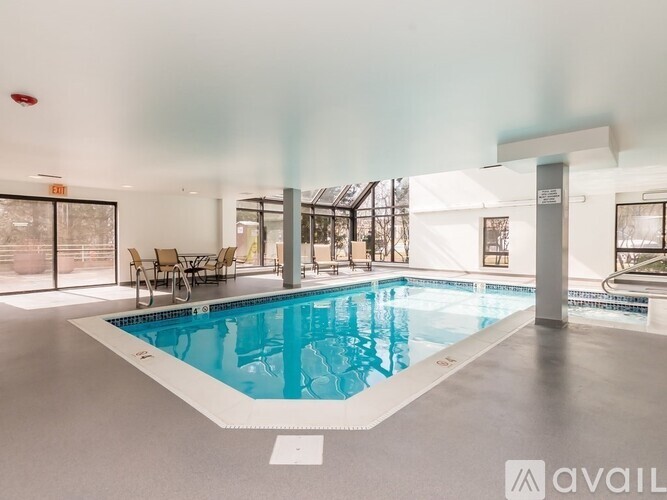 A large indoor swimming pool with a white border and a white floor.