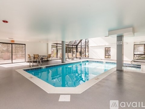 A large indoor swimming pool with a white border and a white floor.