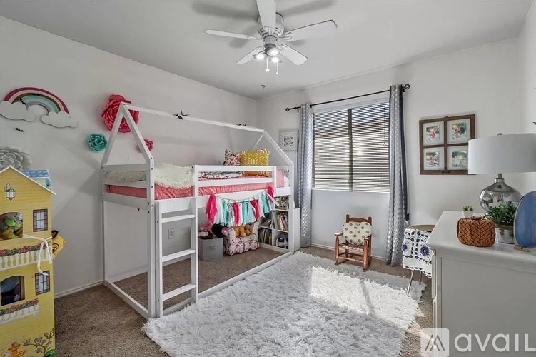 A child's bedroom with a bunk bed and a playhouse.