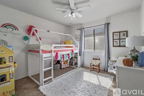 A child's bedroom with a bunk bed and a playhouse.