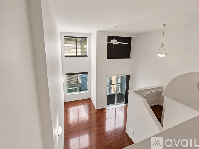 A room with a wooden floor and a ceiling fan.