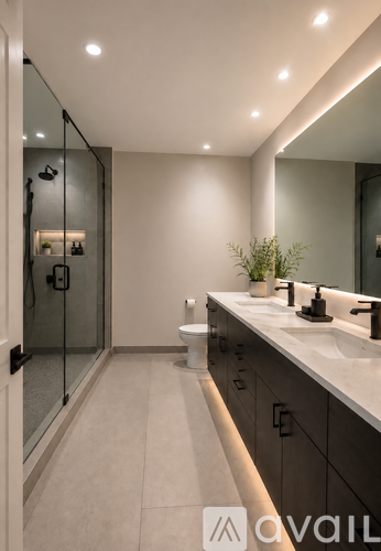 A bathroom with a walk-in shower and a vanity with a mirror.