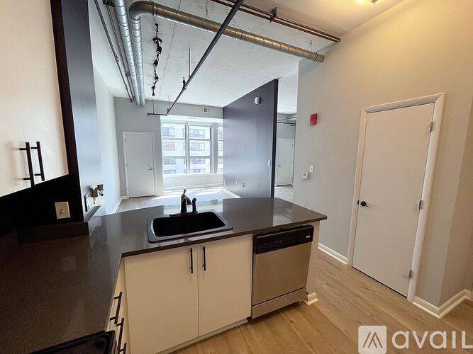 A kitchen with a sink and a refrigerator.