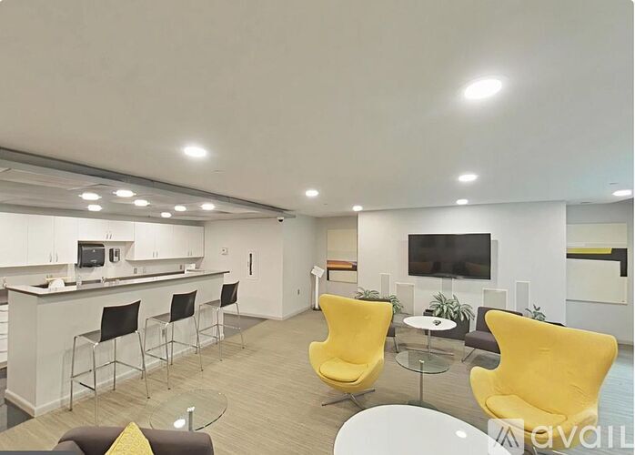A modern living room with a bar area and a television.