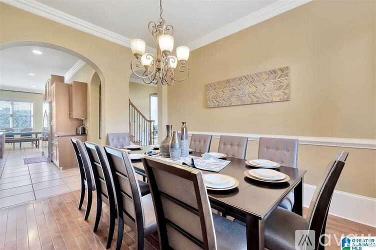 A dining room with a table set for six.