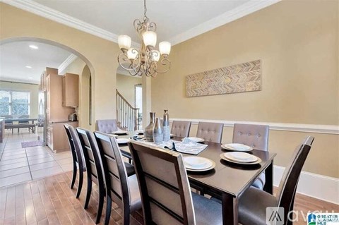 A dining room with a table set for six.