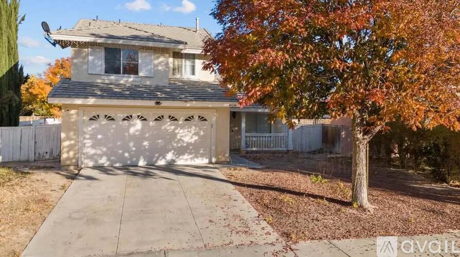 A house with a tree in front of it is for sale.