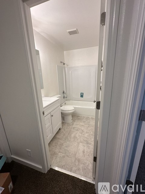 A bathroom with a toilet, sink, and bathtub.