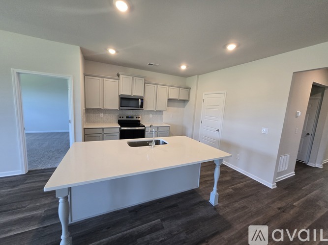 A kitchen with a table in the middle of the room.