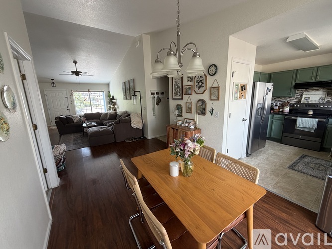 A dining room with a wooden table and chairs.