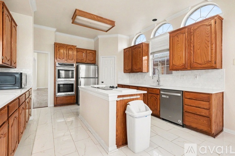 A kitchen with wooden cabinets and a white countertop.