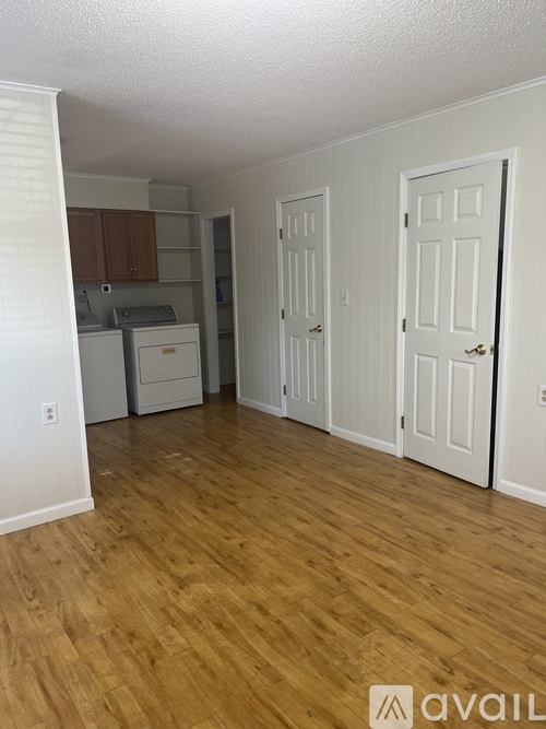 A kitchen area with a washer and dryer.