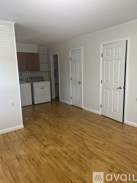 A kitchen area with a washer and dryer.