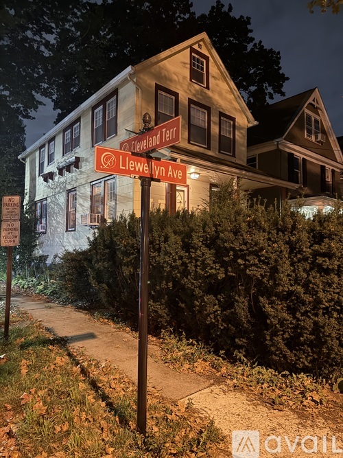A sign for Cleveland Terrace stands in front of a house.