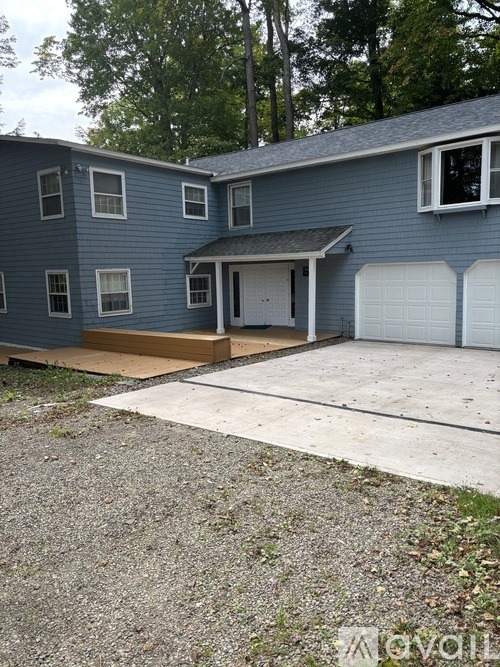 A blue house with a white garage door.