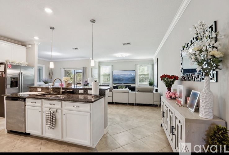A modern kitchen with a large island and a view of the mountains.