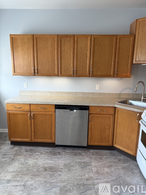 A kitchen with wooden cabinets and a granite countertop.