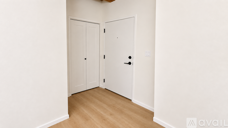 A room with two doors and a wooden floor.