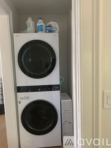 A white LG washing machine and dryer in a small laundry room.