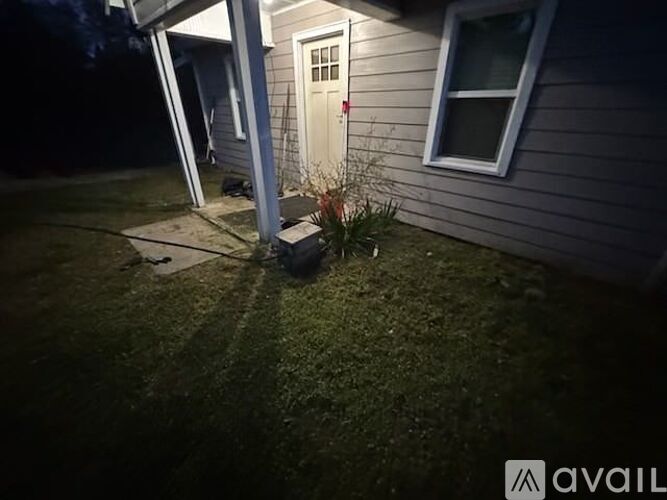 A house with a white door and a window is visible at night.