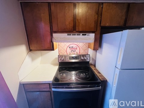 A kitchen with a stove and a refrigerator.