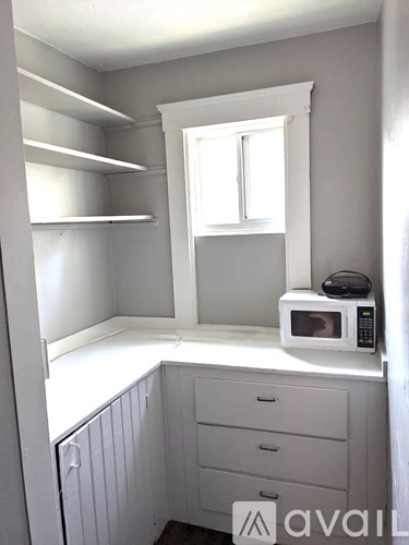 A small kitchen with a microwave on the counter.