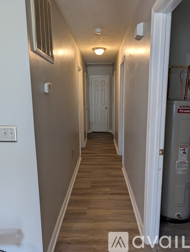 A long hallway with a door at the end.