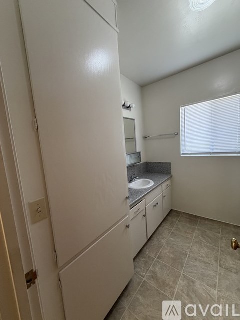 A bathroom with a sink and a mirror.