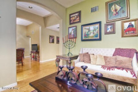 A living room with a couch and pictures on the wall.