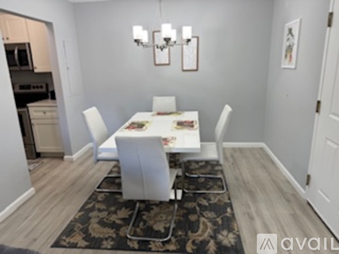 A dining room with a table set for four.