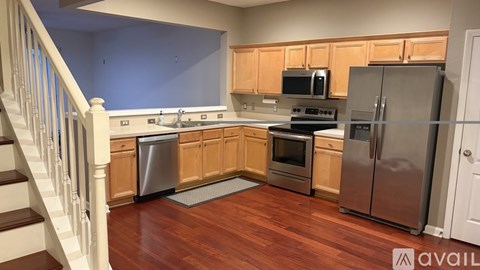 A kitchen with wooden cabinets and stainless steel appliances.