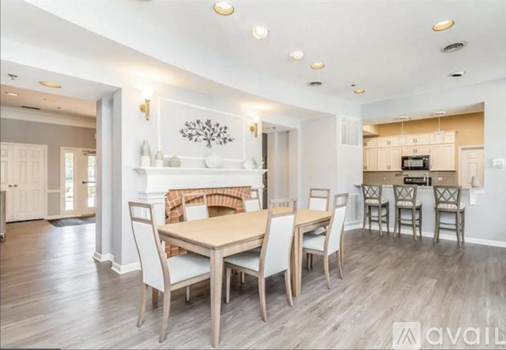 A dining room with a wooden table and chairs.