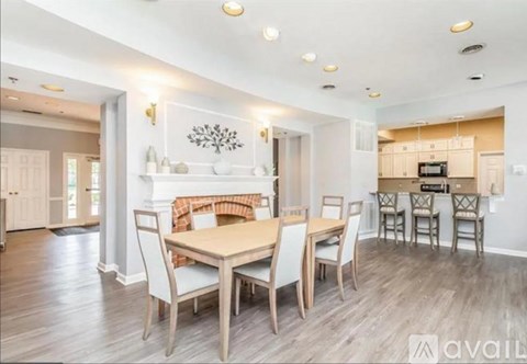 A dining room with a wooden table and chairs.