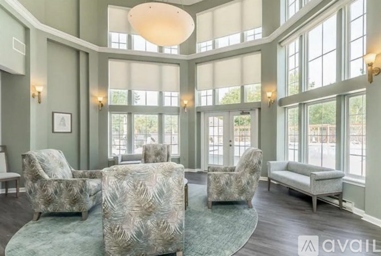 A living room with a large rug and a couch.