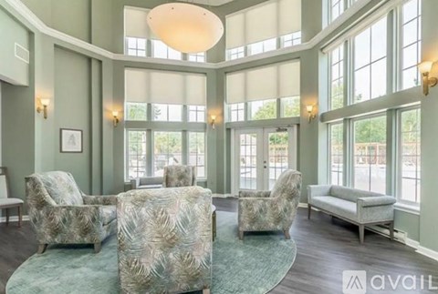 A living room with a large rug and a couch.