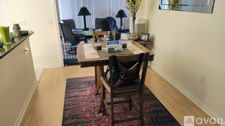 A dining room with a table and chairs.