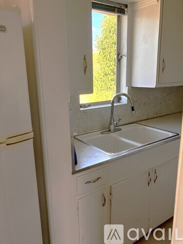 A kitchen with a sink and a window.
